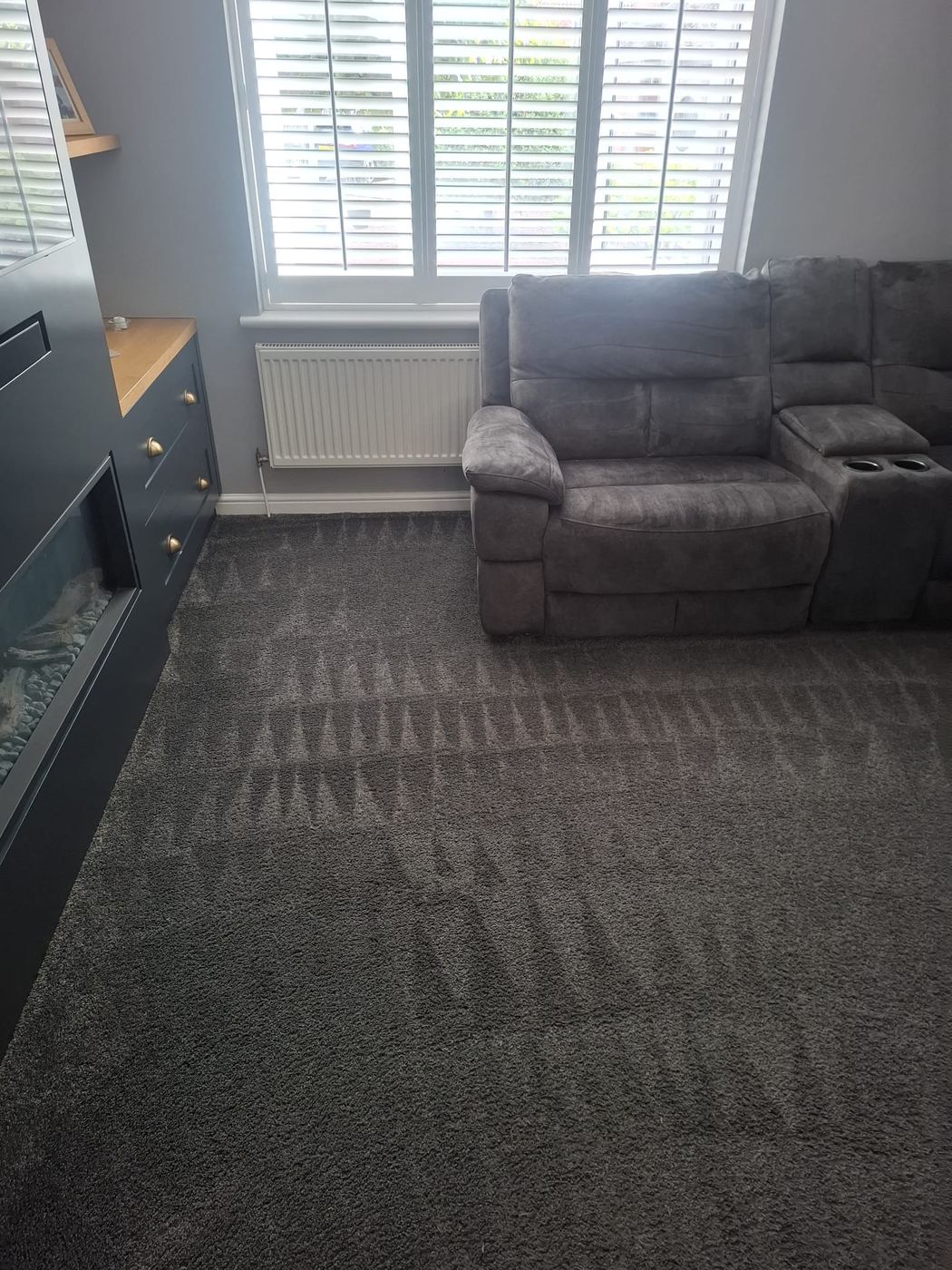 Freshly cleaned living room carpet showing extraction lines in the pile after hot water extraction