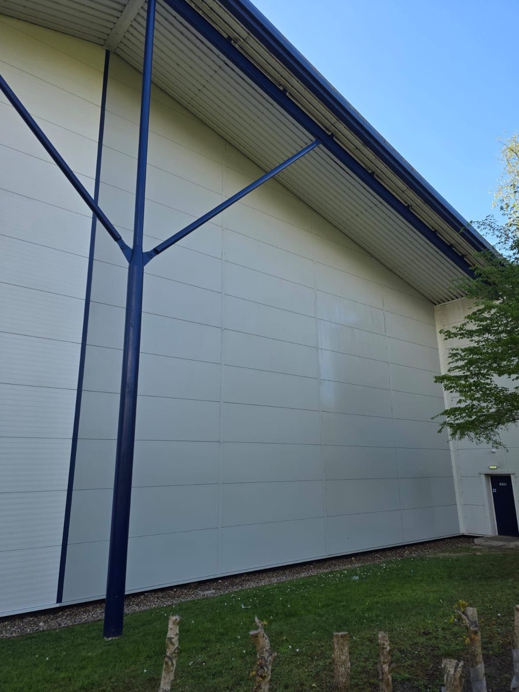 Large white industrial cladding wall fully cleaned by Eastrada